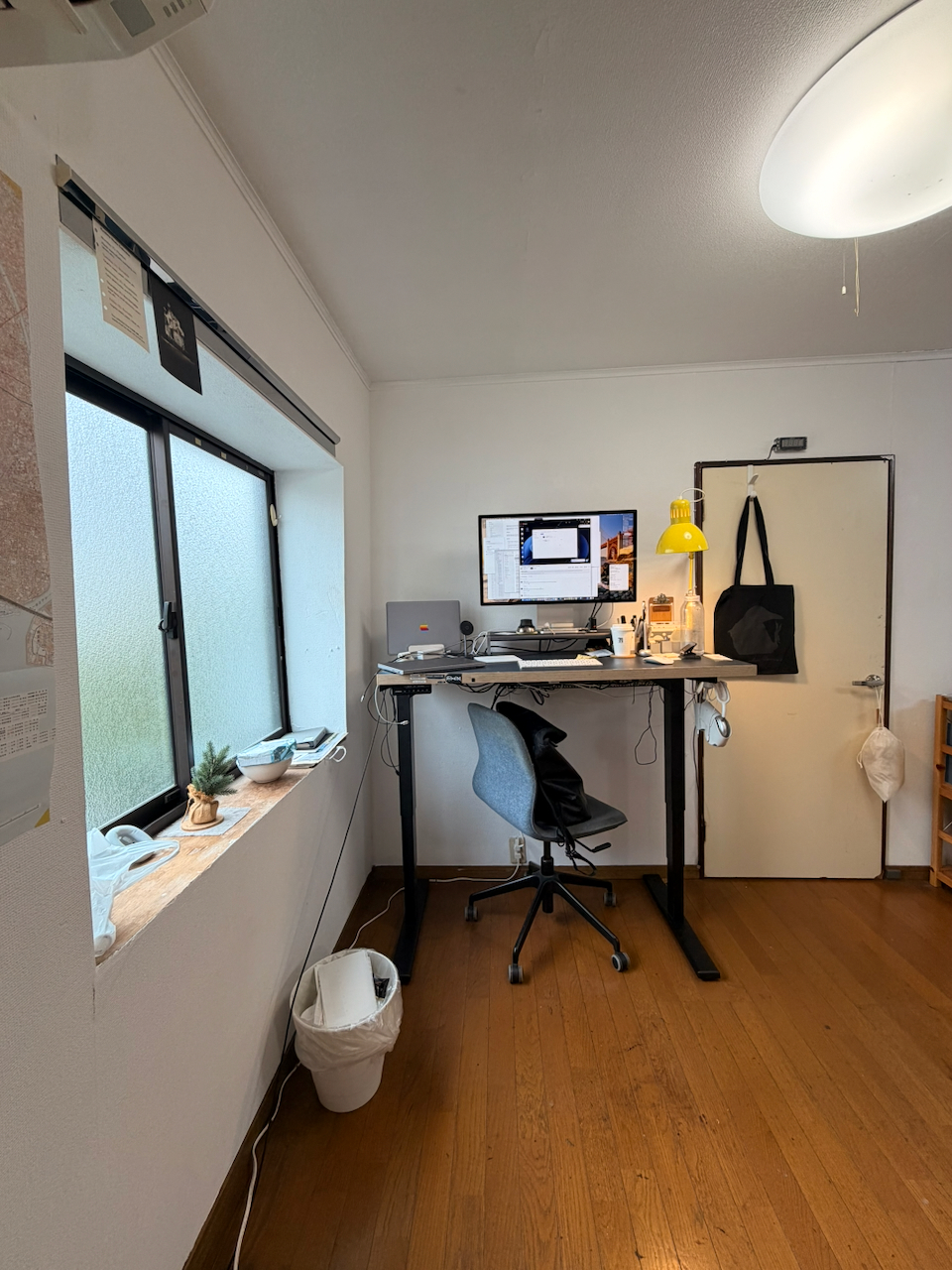 The computer desk beside the studio window
