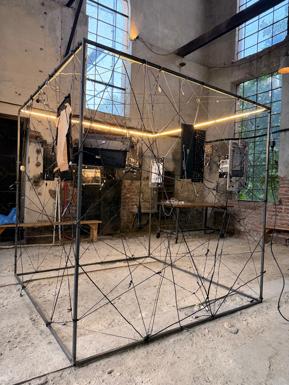 The assembled cube with illuminated edges and suspended photographs
