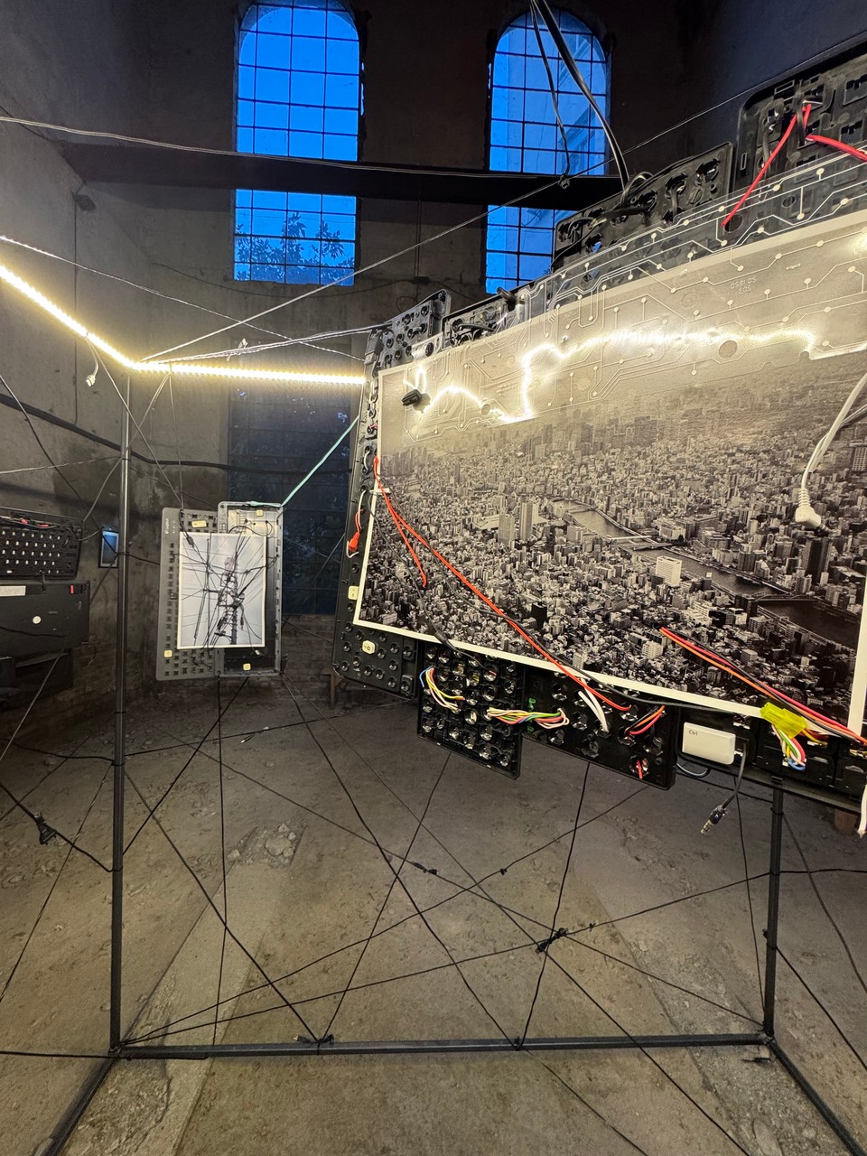 Urban photographs suspended inside the illuminated cube