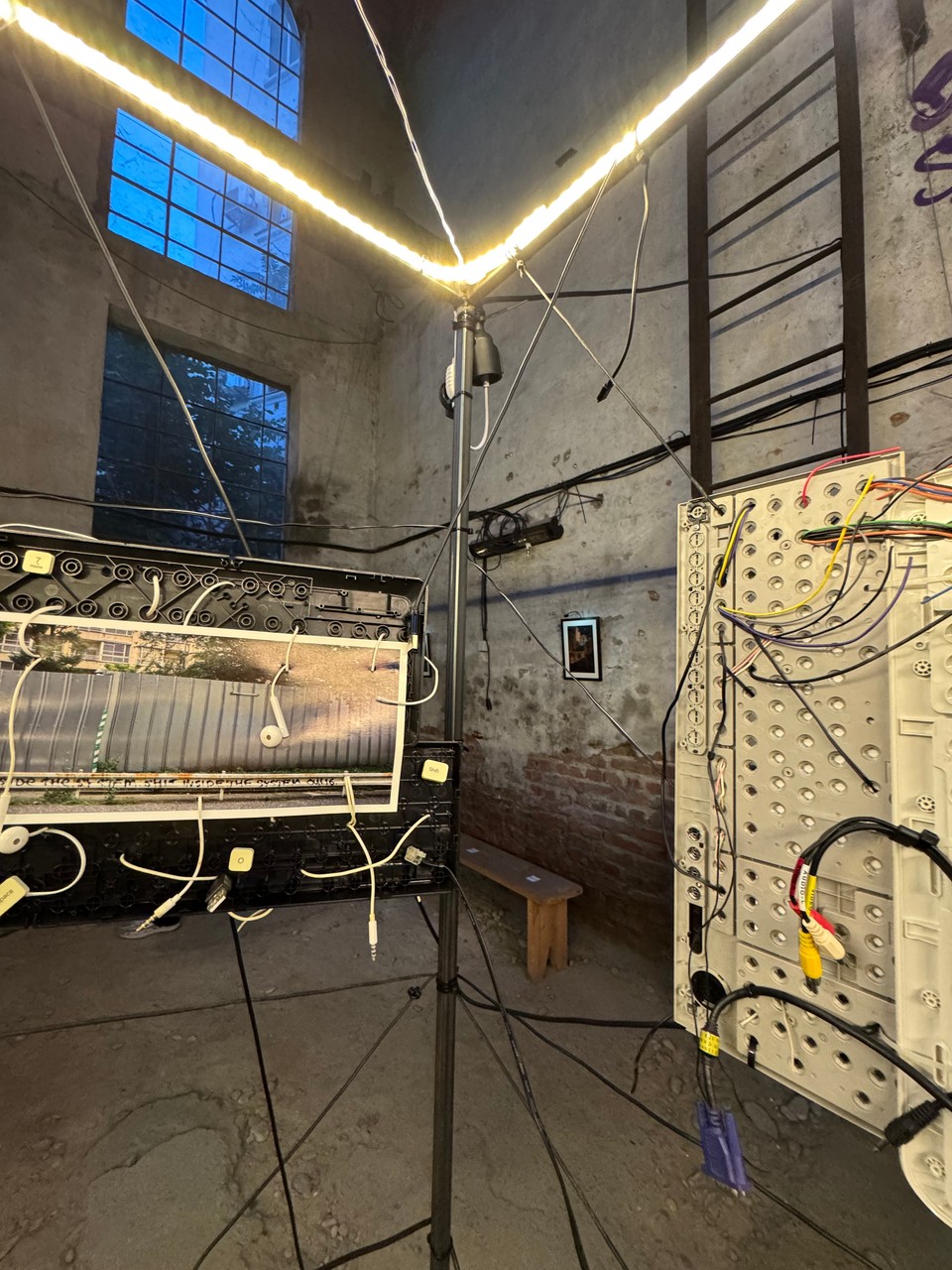 Photographs connected by cables below the glowing edge of the cube